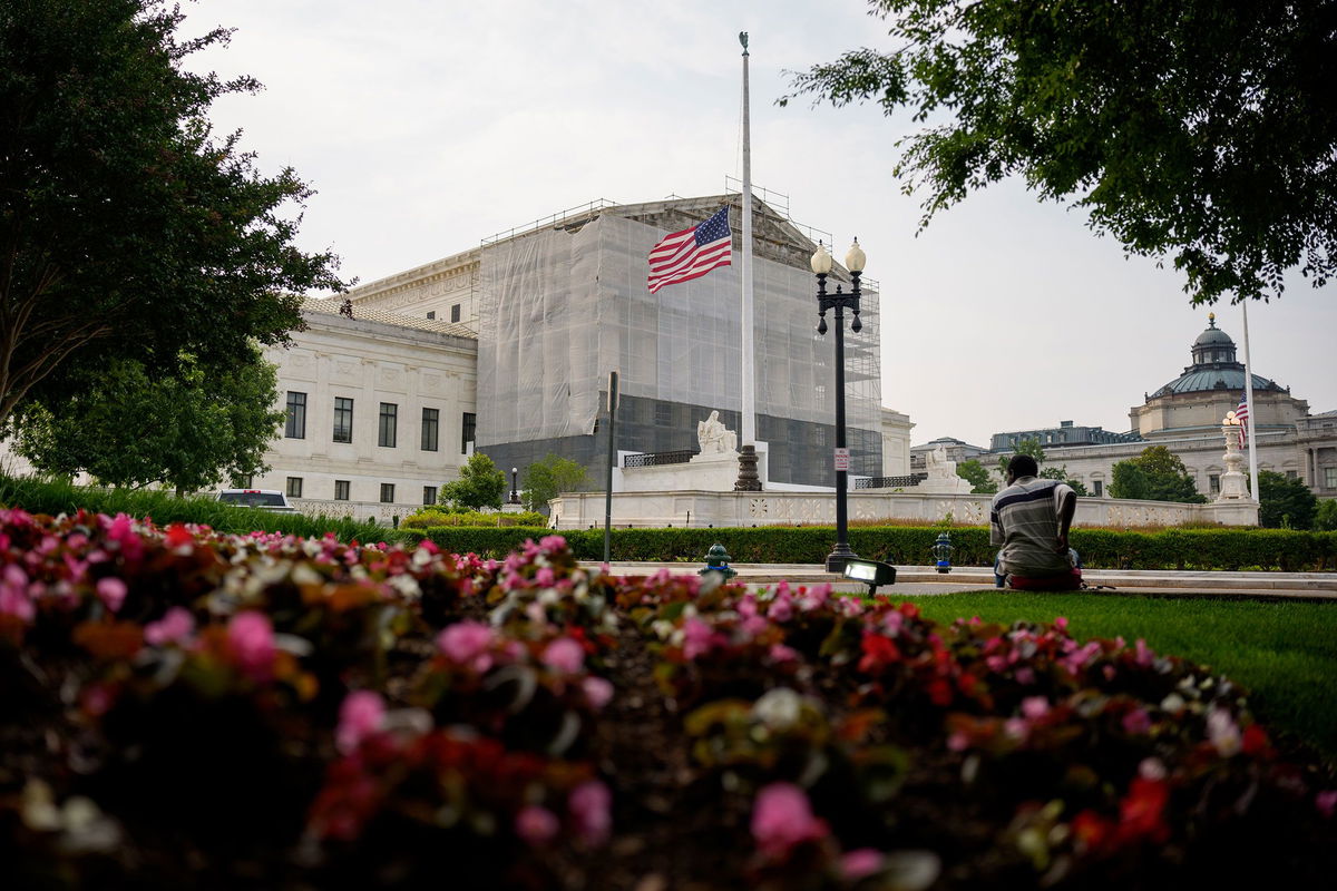 <i>Andrew Harnik/Getty Images via CNN Newsource</i><br/>A person rests in front of the U.S. Supreme Court on June 5