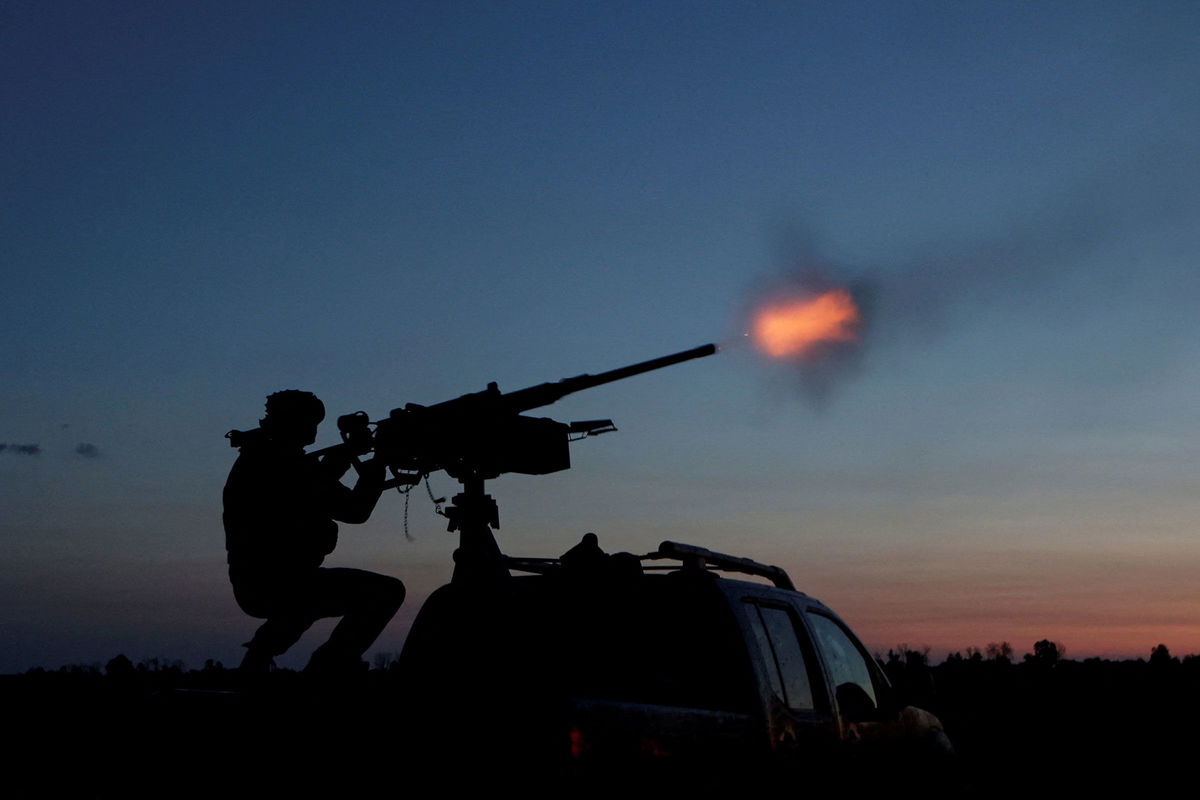 <i>Sofiia Gatilova/Reuters via CNN Newsource</i><br/>A Ukrainian Armed Forces serviceman fires a machine gun towards a Russian drone in the Kharkiv Region of Ukraine on June 2.