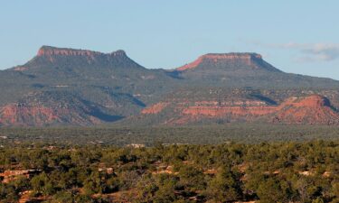 The two bluffs known as the "Bears Ears" stand off in the distance at sunset in the Bears Ears National Monument in May 2017