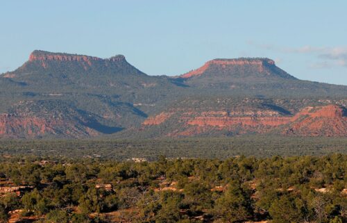 The two bluffs known as the "Bears Ears" stand off in the distance at sunset in the Bears Ears National Monument in May 2017