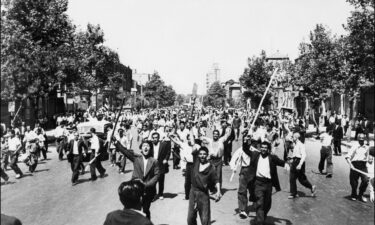 Pro-monarchy rioters take to the streets of Tehran in August 1953.