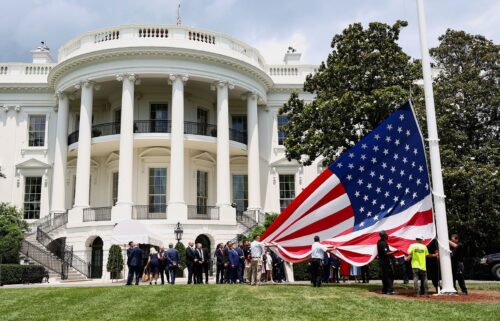 President Donald Trump speaks as a flagpole is installed on the South Lawn of the White House on June 18