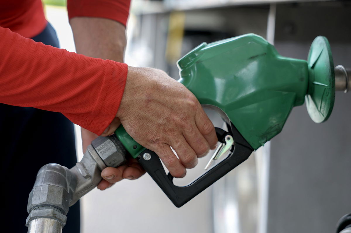 <i>Joe Raedle/Getty Images via CNN Newsource</i><br/>Arley Perez pumps diesel fuel into his truck at a Shell station on April 10