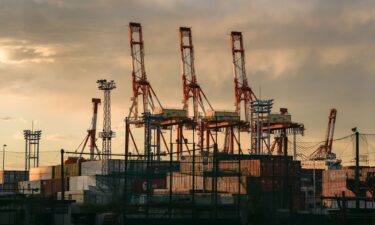 Containers under gantry cranes at a shipping terminal in Yokohama