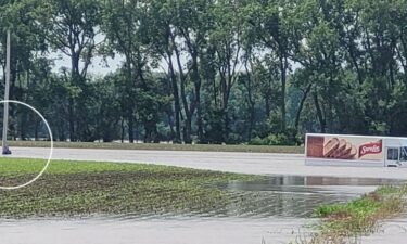 Man was found clinging to a power pole after driving around a barricade and through floodwaters in Kansas on Thursday.