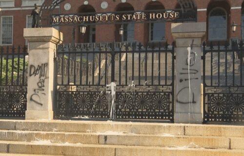Someone splattered white paint and sprayed black paint onto the front entrance of the Massachusetts State House in Boston on July 23.