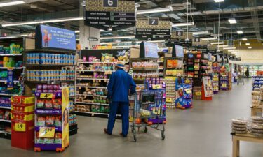 Shoppers walk the aisles of a Kroger supermarket on October 14