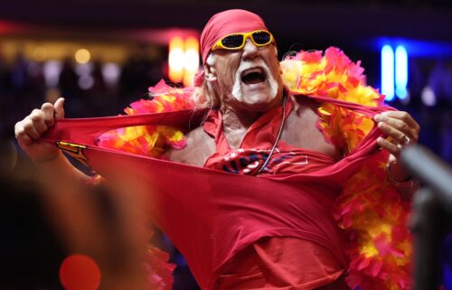 Hollywood Hulk Hogan puts a choke hold on the neck of Utah Jazz basketball star Karl Malone at a pay-per-view wrestling match Sunday July 12