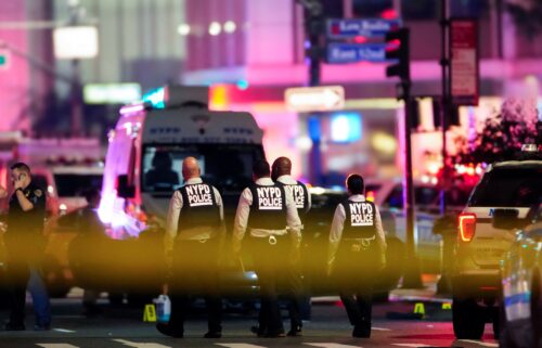 NYPD officers work near the scene of shooting in Manhattan Monday.