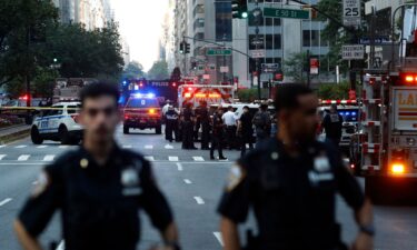 Police officers and emergency vehicles respond to a shooting in Midtown Manhattan on July 28.