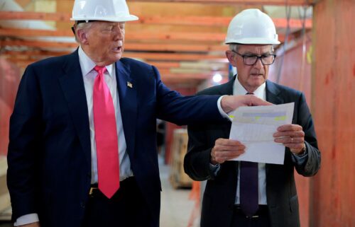 Stuart Levenbach (center) stands with Donald Trump.