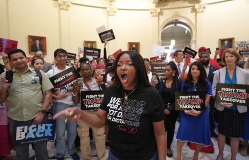Rep. Jasmine Crockett protests redistricting plans before the hearing of the House Select Committee on Congressional Redistricting at the Capitol in Austin