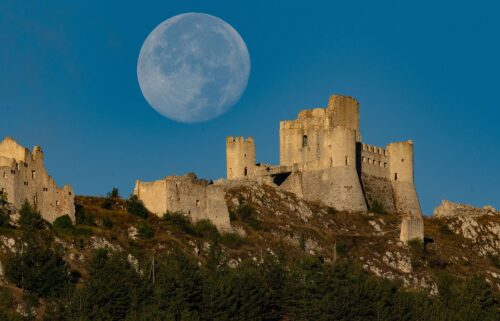 The full sturgeon moon appears in the sky over Rocca Calascio Castle in Calascio