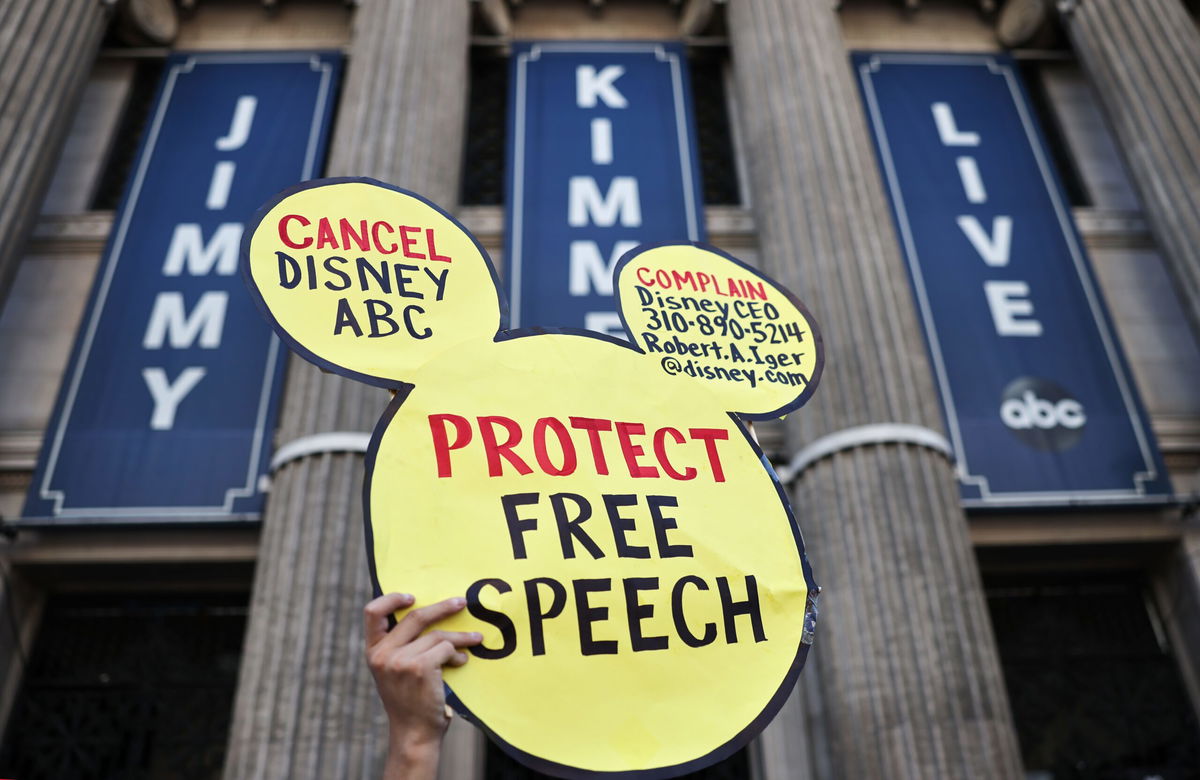 <i>Mario Tama/Getty Images via CNN Newsource</i><br/>A demonstrator waves a "Protect Free Speech" sign following a protest against the suspension of the "Jimmy Kimmel Live!" show
