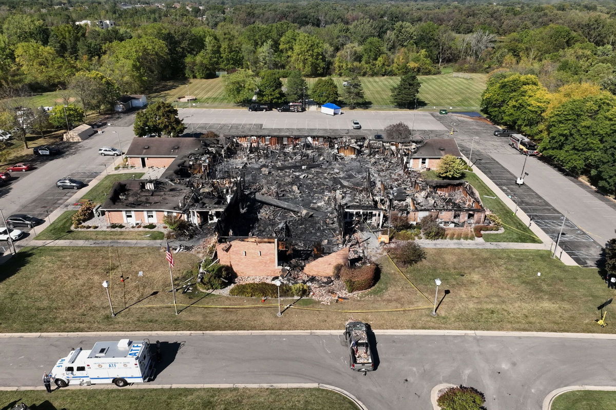 Church members and residents reunite at the Trillium Theater located across the street from the site of the shooting and fire at the Church of Jesus Christ of Latter-day Saints in Grand Blanc