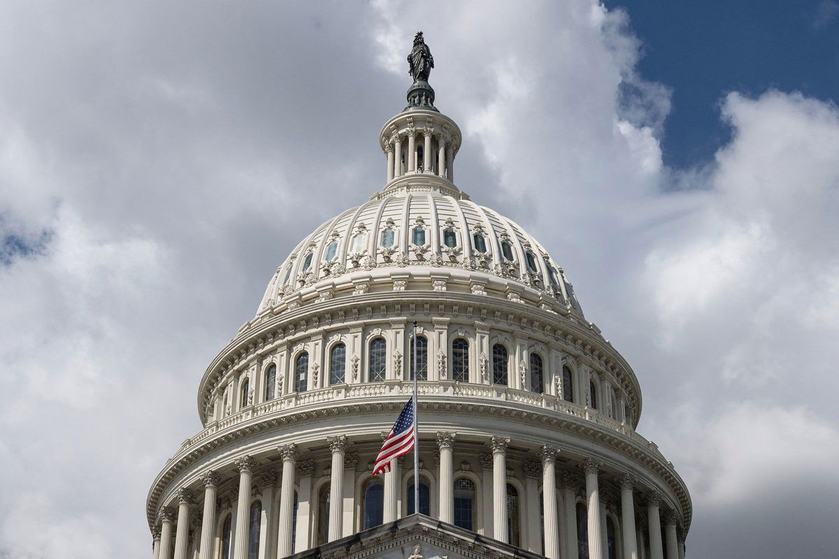 The US flag flies at half-mast on the US Capitol in Washington