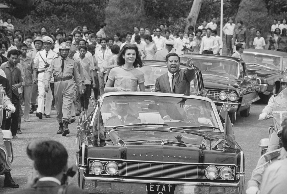 Jacqueline Kennedy and Chief of State Prince Norodom Sihanouk are cheered during a motorcade in Phnom Penh.