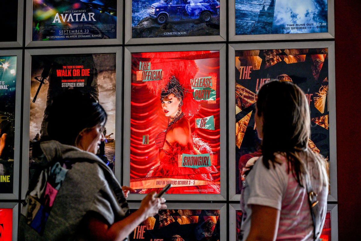 Fans take pictures in the lobby as they attend "Taylor Swift: The Official Release Party of a Showgirl" at AMC Montgomery 16 movie theater in Bethesda
